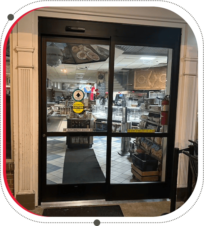 A large glass door in the middle of a restaurant.