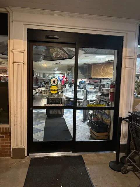 A large glass door in the middle of a store.