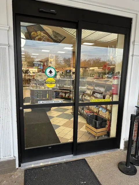 A store front with a large glass door.